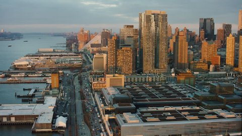 Aerial view of the buildings and piers by the Hudson River, New York City, during sunset in winter. Establishing shot. Shot on 4k RED camera.