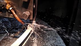 video clip metal processing with a chisel close-up with coolant flow in slow motion