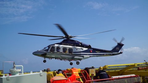 KELANTAN, MALAYSIA - APRIL 10 2019 : A commercial helicopter Agusta AW 139 model from Weststar Group company, landing on top of oil and gas platform helideck.