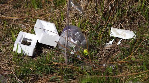 Plastic bottle and Styrofoam in grass, polluted environment, Plock, Poland