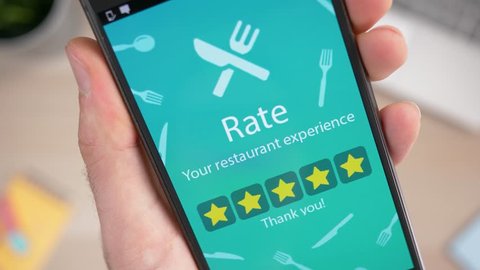 Rating 5 stars a restaurant on a smartphone rating app