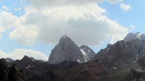 Glitch effect. The rock beneath the clouds. Time Lapse, Pamir