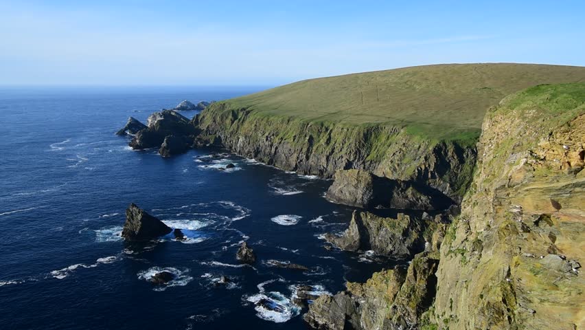 Spectacular coastline with sea cliffs and stacks, home to breeding sea birds at Hermaness, Unst, Shetland Islands, Scotland, UK Royalty-Free Stock Footage #1027639691