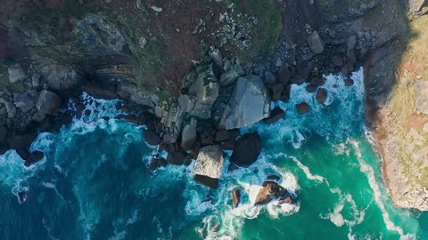 Detail of sea waves colors breaking in the coast of Lekeitio (187), Basque country - drone aerial footage - graded