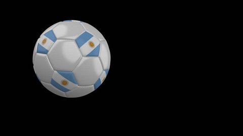 Soccer ball with the flag of Argentina flies past the camera, slow motion, 4k footage with alpha channel