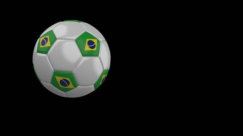 Soccer ball with the flag of Brazil flies past the camera, slow motion, 4k footage with alpha channel