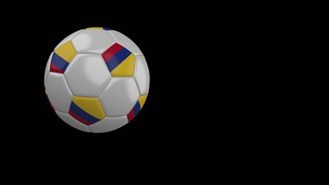 Soccer ball with the flag of Colombia flies past the camera, slow motion, 4k footage with alpha channel