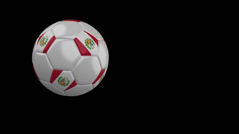Soccer ball with the flag of Peru flies past the camera, slow motion, 4k footage with alpha channel