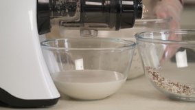 A close-up demonstration video of the almond milk making process. Pure milk is separated from the pulp. Vegetarian product, healthy nutrition concept