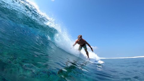 Surfer rides the barreling ocean wave at the Jailbreaks surf spot in Maldives Stock Video