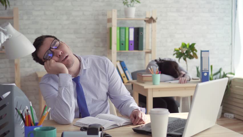 sleepy workers in the office,a man and a woman sleeping at work, answering the phone Royalty-Free Stock Footage #1027656074