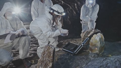 Investigating and collecting analyzes of strange unsafe stones in the old caves underground