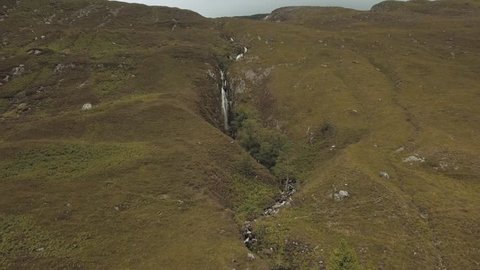 A beautiful waterfall within the nature of North Scotland in the United Kingdom