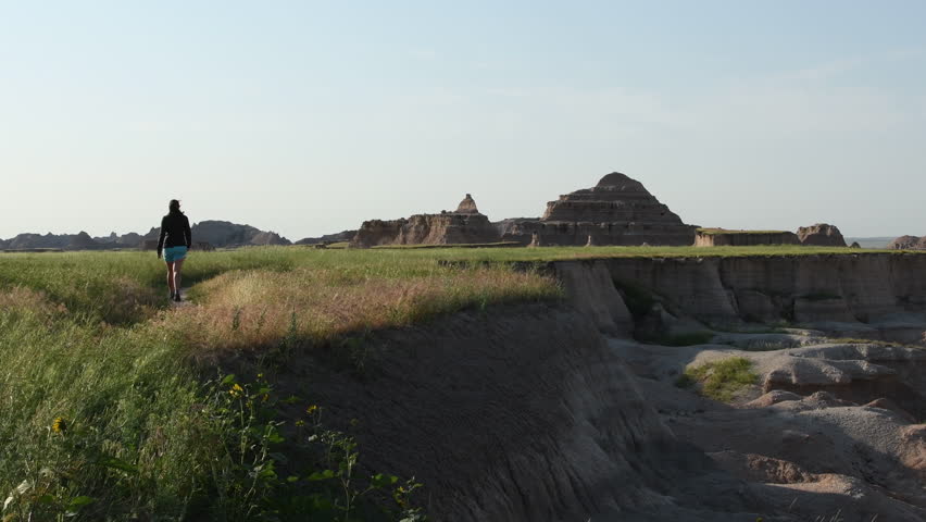 Woman Hikes Through Meadow in Badlands Wilderness