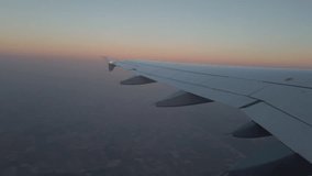 Airplane wing window view in low light at sunrise - Powered by Shutterstock - Get 15% off with code: PIKWIZARD15