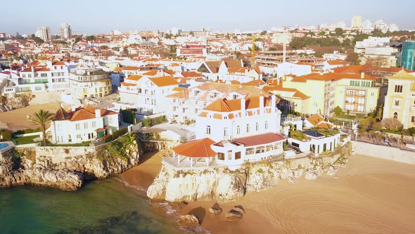 Aerial, pan, drone shot, around the cityscape, overlooking Palacio Seixas, Marina de Cascais and the coast of the Atlantic sea, in Cascais, Portugal