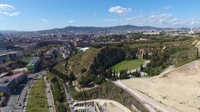 Full HD Video filmed by drone in the Montjuic area, in Barcelona. You see the great city cemetery, the seaport, and the mountain of Montjuic