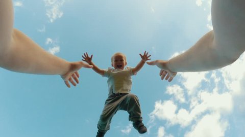 Father hands throw up little cute smiling son playing together clear blue sky in background POV shot happy family having fun outdoor relaxing at summer sunny day low angle