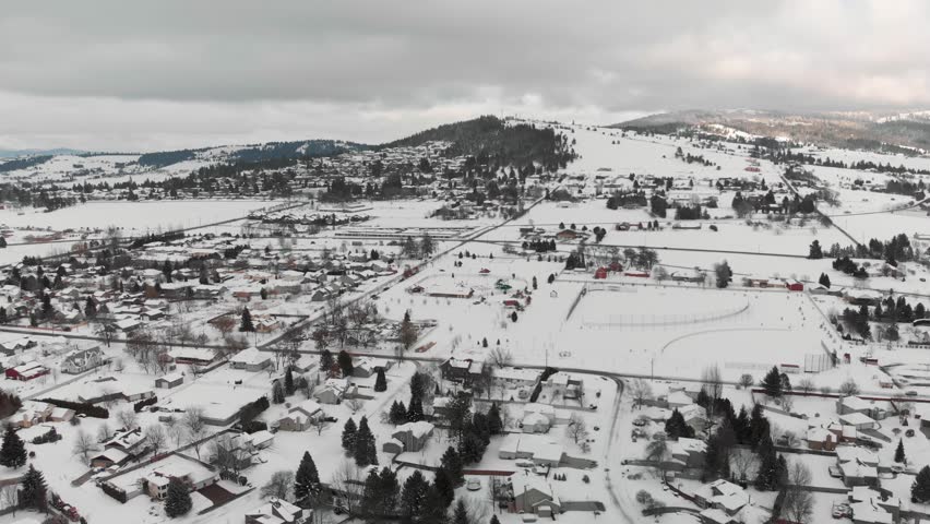Drone Shot - Snowy landscape. Wide shot of Spokane, Washington on the South Hill flying towards Tower Mountain
