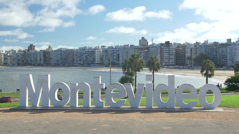 Montevideo Sign - Beach view, city skyline. Montevideo, Uruguay - Circa 2019