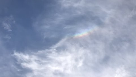 time lapse full hd . Rolling clouds in the sky with rainbow seen and disappear in a sunny day without rain