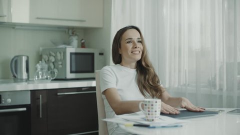 Young woman having break at work on laptop computer at home. Business woman stop using laptop at kitchen. Happy person finish work notebook at home. Female freelancer have break at online work