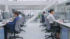 In Modern Office: Diverse Team of Managers and Specialists Work on Computer, Have Discussion with Colleagues and on the Phone. Young and Motivated Business people in Open Office. - Powered by Shutterstock - Get 15% off with code: PIKWIZARD15
