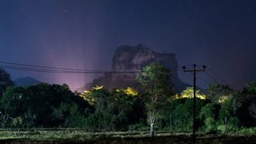 Night sky time lapse over Sigiriya rock fortress in Sri Lanka