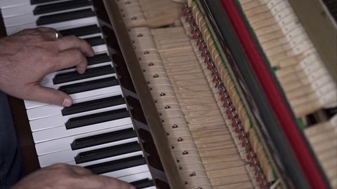 Musician plays open piano, Slow Motion Top View Medium shot with shallow depth of field