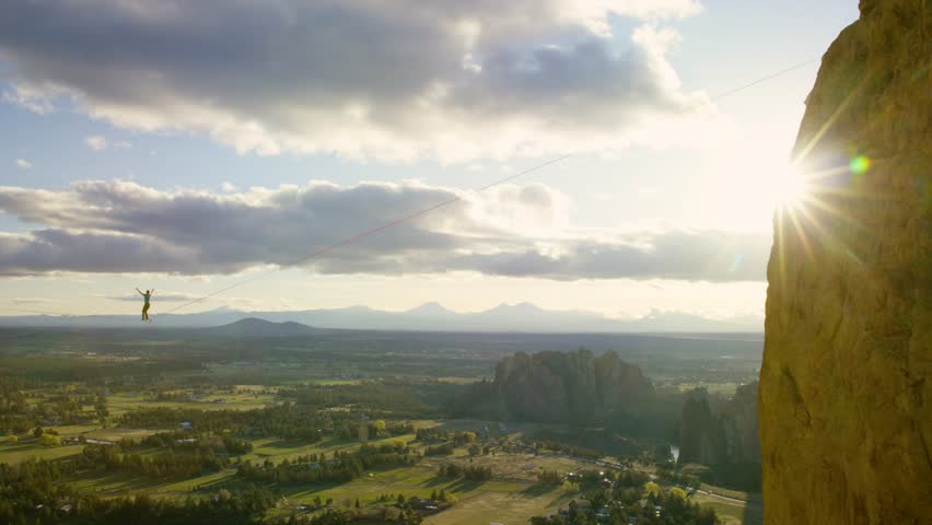 Highliner walking epic line at sunset. Smith Rock, Oregon.