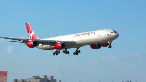MIAMI, FL - 2019: Virgin Atlantic Airbus A340-600 Commercial Jet Airliner named Lady Luck Landing at MIA Miami International Airport Arriving from London Heathrow on a Sunny Day in South Florida