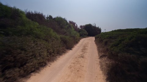POV shot from a camera attached to the front of an off road vehicle driving through beautiful trails and paths in sardinia