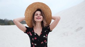 Young woman in hat on a beach. Summer time season 