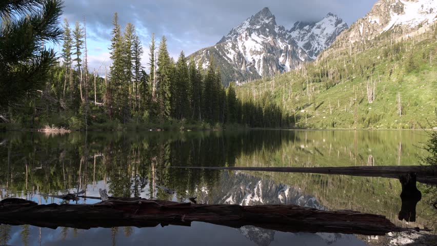 Snow capped mountain reflecting on Jenny Lake in Grand Teton National Park, Wyoming