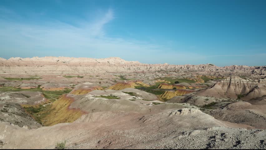Colorful rock formations under a blue sky at Badlands National Park in the South Dakota desert