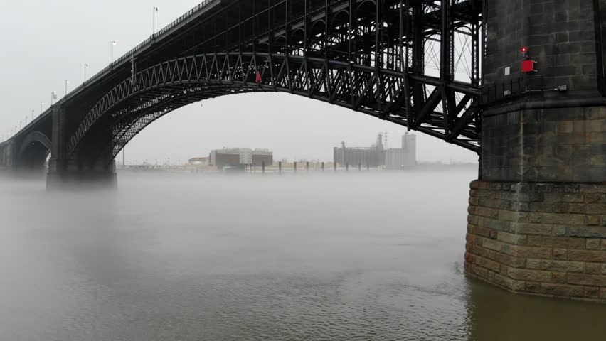 Slow-rising aerial clip revealing Eads Bridge in St. Louis, spanning the Mississippi River.