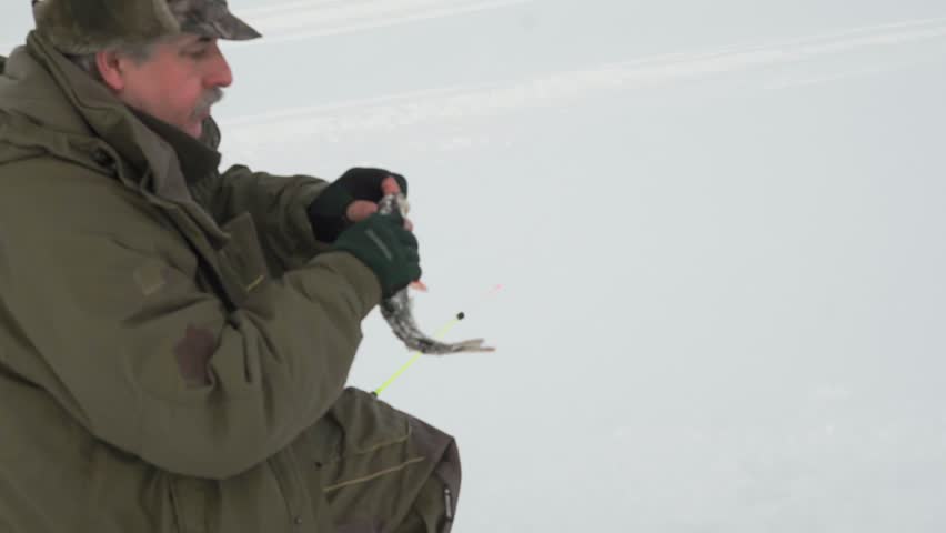 fisherman fishing in winter