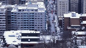 Cinematic static footage zoomed in seem from above from downtown (centre-ville) in Montreal, Quebec, Canada during winter season.