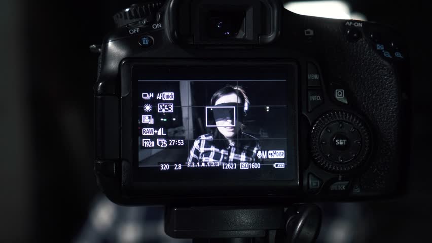 Related young woman hostage blindfolded with a gun to my head, through the camera screen.