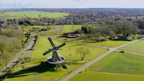 Aerial drone view on the typically Dutch windmill De Windhond in Soest. Traditional Dutch rural farmland landscape.