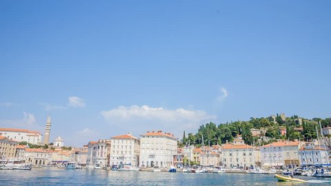 PIRAN, SLOVENIA - 7. AUGUST 2018 A small yellow speedboat is approaching the harbour. It's a nice summer day in a sea town of Piran.