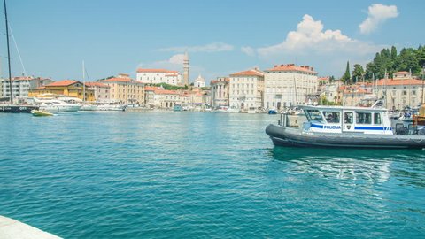 PIRAN, SLOVENIA - 7. AUGUST 2018 A speedboat is approaching the harbor. It came back from fishing. It's a nice summer day in Piran.