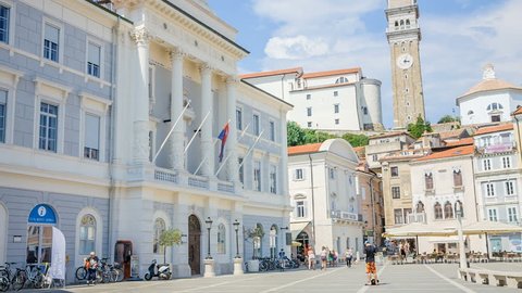 PIRAN, SLOVENIA - 7. AUGUST 2018 Tourists are walking around a Tartini Square and are taking photos, looking at the sites, etc. It's a nice summer day in Piran.