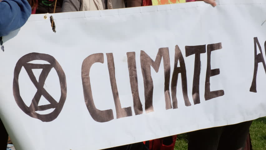 Extinction Rebellion poster to raise awareness to the dangers of Climate Change during a large demonstration in London, UK Royalty-Free Stock Footage #1027776404