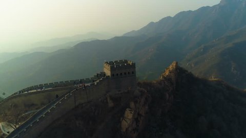 Great Wall of China and Green Mountains in Summer Sunset. Aerial View. Drone is Orbiting