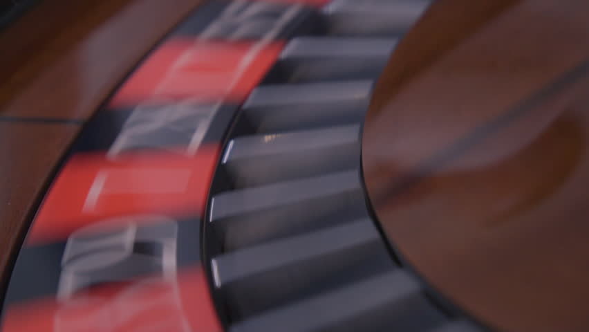A ball on black 11 spins around on a roulette wheel CLOSE UP | Shutterstock HD Video #1027784039