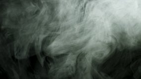 Close up for thick white smoke spreading over black background. Stock footage. Dense fog flying isolated in the dark. - Powered by Shutterstock - Get 15% off with code: PIKWIZARD15