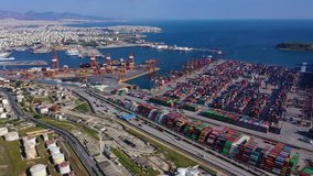 Aerial video of industrial cargo container loading terminal located in mediterranean port