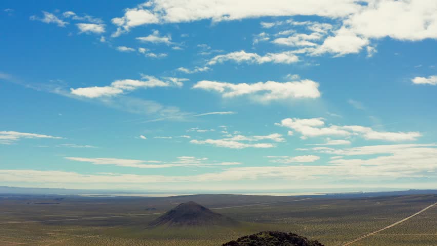 Smooth reverse aerial to reveal butte formation in California City, California