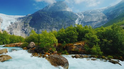 Pan shot: The incredible nature of Norway is a turbulent river from the melted waters of the Briksdal Glacier